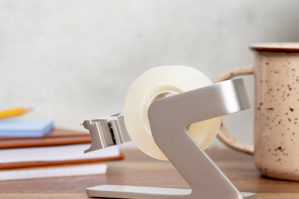 Side view of the silver tape dispenser showing the hook at the front