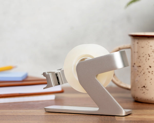 Side view of the silver tape dispenser showing the hook at the front