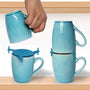 A second mug placed upside down on an ELYPRO Mug Stacker above an upright mug in a kitchen cabinet