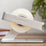 Silver ELYPRO tape dispenser holding a roll of clear tape on a wooden desk