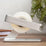 Silver ELYPRO tape dispenser holding a roll of clear tape on a wooden desk