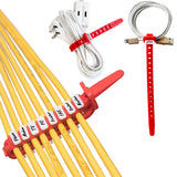 Red cable ties on a white background holding a folded extension cord, a coiled charging cable and a row of yellow cables tagged Phone, Modem, TV, PC and Printer