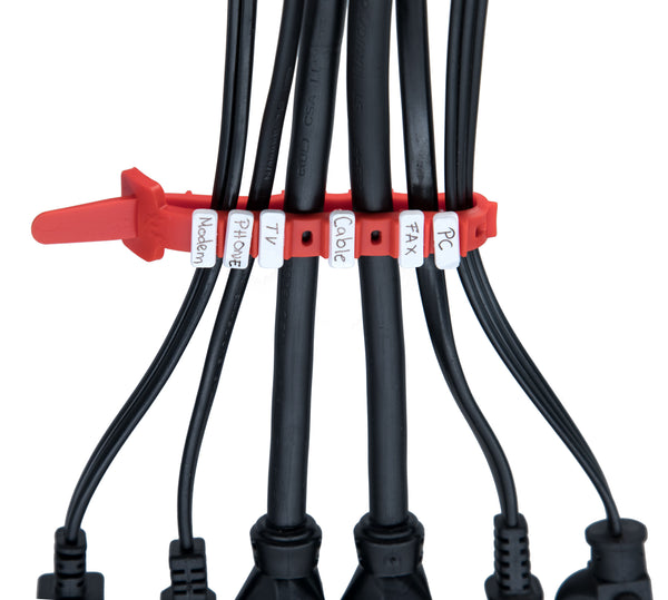 Red cable tie clipped across six black power cords, each marked with a white label reading Modem, Phone, TV, Cable, FAX and PC